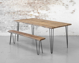 Rustic, reclaimed timber scaffold board dining table on bare steel hairpin legs