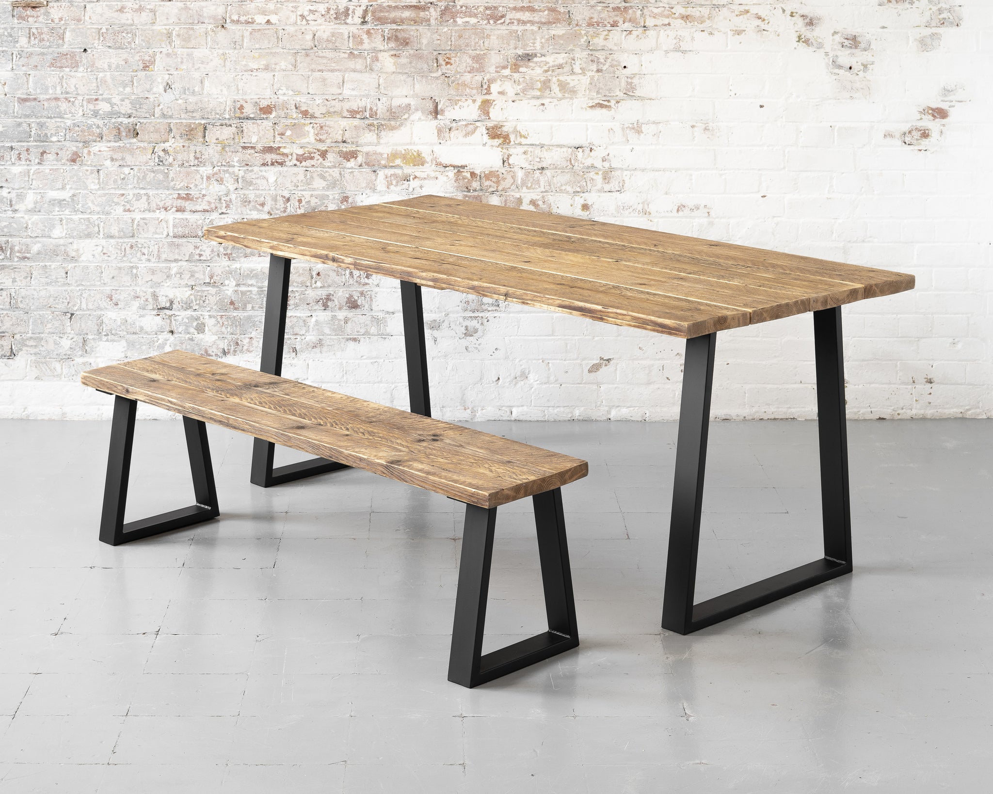 Rustic, industrial, reclaimed timber scaffold board dining table on matte black steel trapezium base